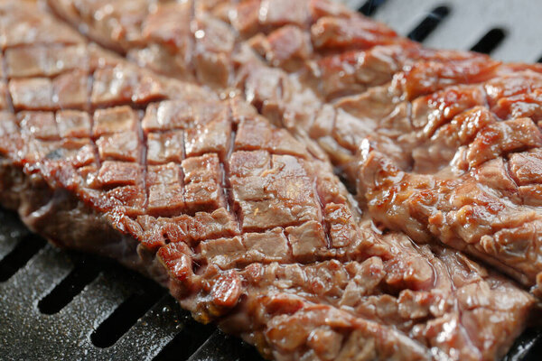 barbecue with meat on the grill, close up