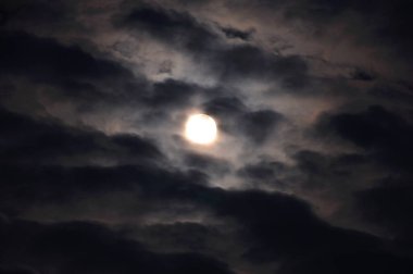 Gece gökyüzünde bulutlu ay manzarası     