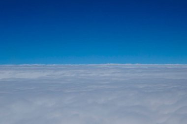 Mavi gökyüzü ve beyaz, bulutlar uçak yüksekliğinden alındı. 