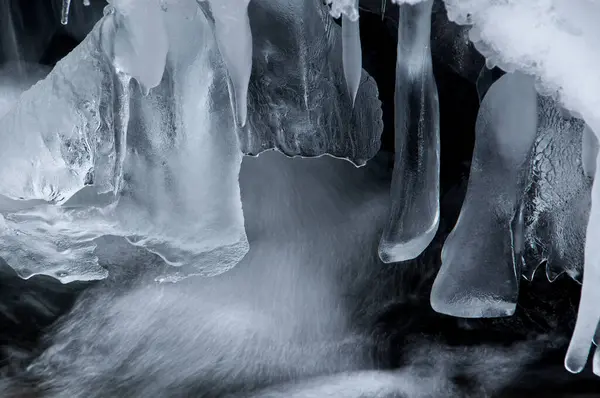 a waterfall with ice hanging over it