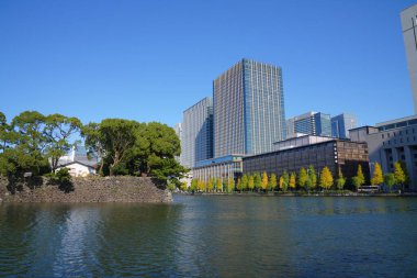 İmparatorluk Sarayı, Tokyo, Japonya çevresindeki hendeğe bakan modern binalar.