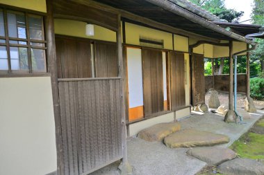 Sürgülü kapıları ve taş yolu olan geleneksel Japon evi.