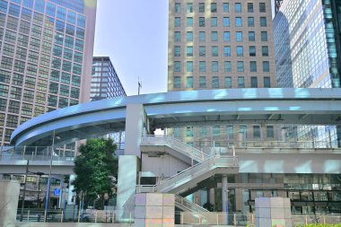 Pedi Shiodome shopping complex at the background of New Transit Yurikamome elevated railway line at Shiodome area of Minato. Tokyo. Japan clipart