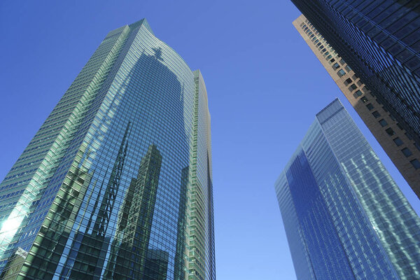 Modern city architecture on a sunny day. View of skyscrapers against blue sky