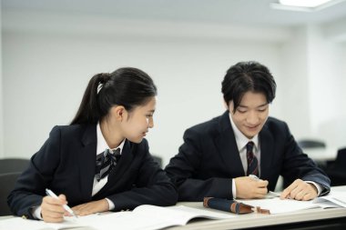 Sınıfta çalışan üniformalı Japon öğrenciler.
