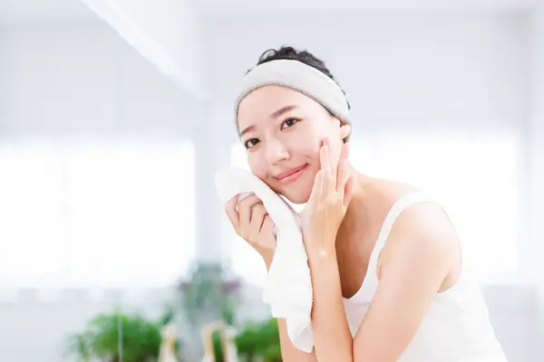 Beautiful Asian woman touching face. Skincare concept