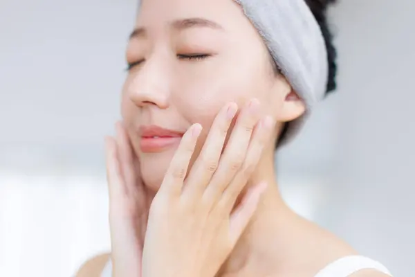 beautiful Japanese woman touching face. Beauty and healthcare concept