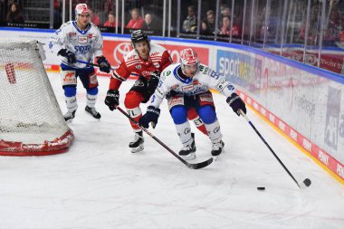 COLOGNE, GERMANY - JANUARY 18, 2023: LOUIS-MARC AUBRY, JOHN RAMAGE. Hockey match DEL Koelner Haie - Schwenninger Wild Wings