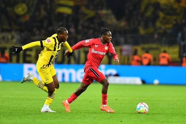 LEVERKUSEN, GERMANY - 29.01.23: Jamie Bynoe-Gittens, Jeremie Frimpong. The Bundesliga match FC Bayer 04 Leverkusen vs Borussia Dortmund at BayArena