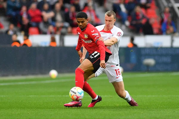 Stock image LEVERKUSEN, GERMANY - 23.04.23: Amine Adli vs Lukas Klostermann. The Bundesliga match FC Bayer 04 Leverkusen vs Red Bull Leipzig at BayArena