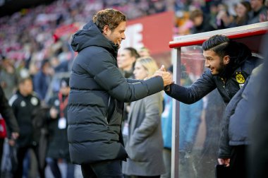 COLOGNE, GERMANY - 20 JANUARY, 2024: Edin Terzic, Nuri Sahin, The football match of Bundesliga 1.FC Koeln vs Borussia Dortmund at Rhein Energie Stadion clipart