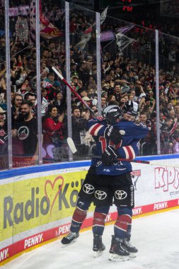 COLOGNE, GERMANY - 8 DECEMBER, 2024: Justin Schuetz, Alexandre Grenier, Hockey match DEL Koelner Haie - Augrsburger Panter at Lanxess Arena clipart