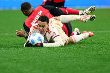 LEVERKUSEN, GERMANY - 15 FEBRUARY, 2025: Jonathan Tah, Jamal Musiala, The Bundesliga match FC Bayer 04 Leverkusen vs FC Bayern Muenchen at BayArena clipart