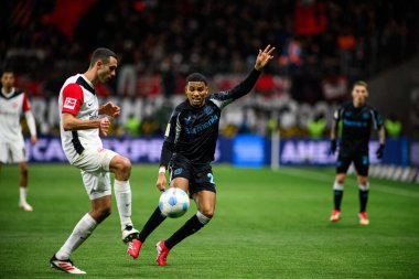 FRANKFURT, GERMANY - 1 Mart 2025: Ellyes Skhiri, Amine Adli - Bundesliga maçı Eintracht Frankfurt - FC Bayer 04 Leverkusen Deutsche Park 'ta. 