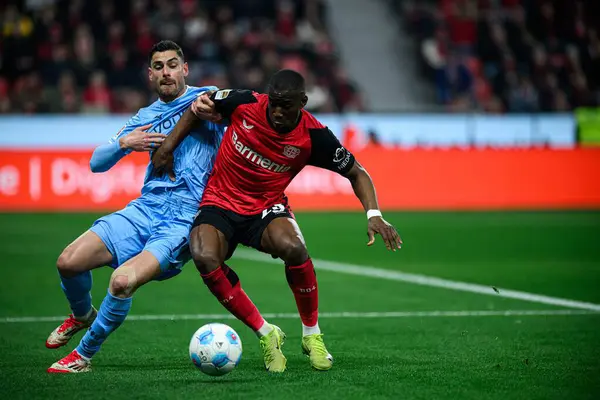 LEVERKUSEN, ALMANY - 28 Mart 2025: Nordi Mukiele, Georgios Masouras - Bundesliga, maç 27. Bayer Leverkusen, Bayarena 'da Bochum' a karşı.