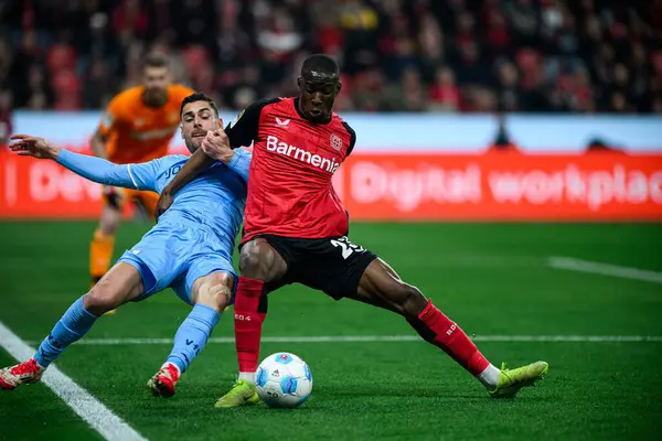 LEVERKUSEN, ALMANY - 28 Mart 2025: Nordi Mukiele, Georgios Masouras - Bundesliga, maç 27. Bayer Leverkusen, Bayarena 'da Bochum' a karşı.