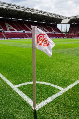 MAINZ, GERMANY - 17 Mayıs 2025: Bundesliga maçından önce MeWA ARENA 'da FSV Mainz 05 logosu olan köşe bayrağı sahada duruyor. Stadyum koltukları ve yeşil alan arka planda görünüyor.