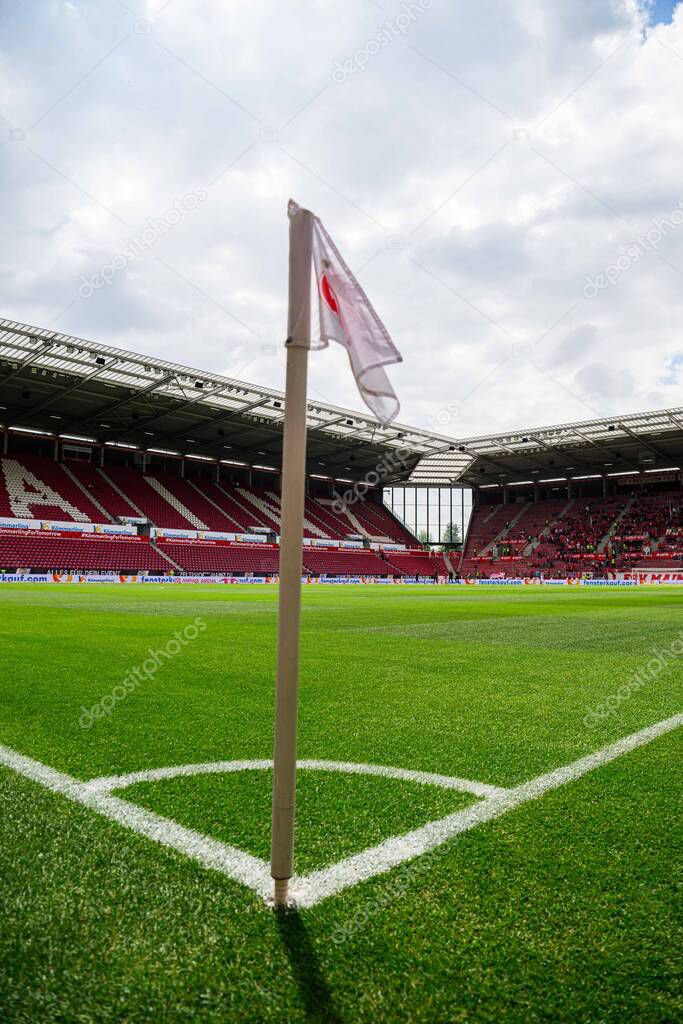 MAINZ, GERMANY - 17 MAY, 2025: Corner flag with FSV Mainz 05 logo stands on pitch at MEWA ARENA before Bundesliga match. Stadium seats and green field visible in background.