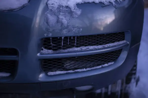 Frozen car bumper, close-up. Winter car service concept.