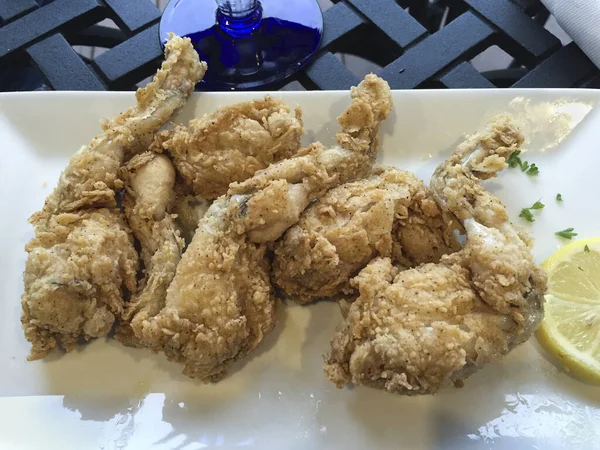 Fried frog legs, frog legs frying. High quality photo