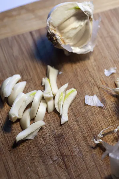 Garlic clove and bulbs on a wood cutting board. High quality photo