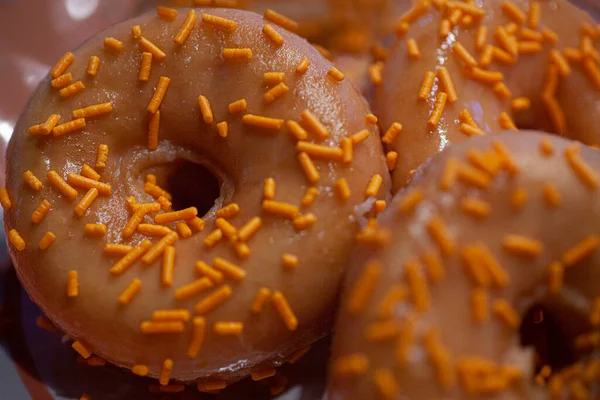 Orange glazed donuts with orange sugar sprinkles and coffee. High quality photo