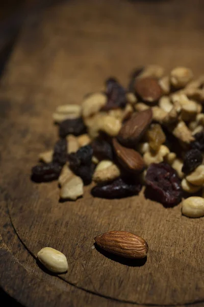Mixed nuts trail mix on antique cutting board. High quality photo