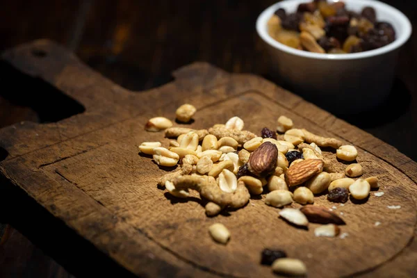 Mixed nuts trail mix on antique cutting board. High quality photo