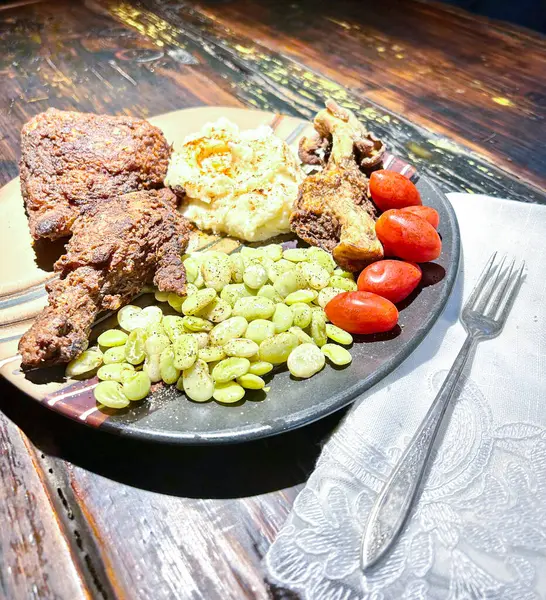 Cooked chicken dinner with vegetables on the side. High quality photo