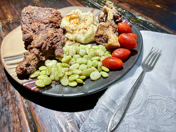 Cooked chicken dinner with vegetables on the side. High quality photo