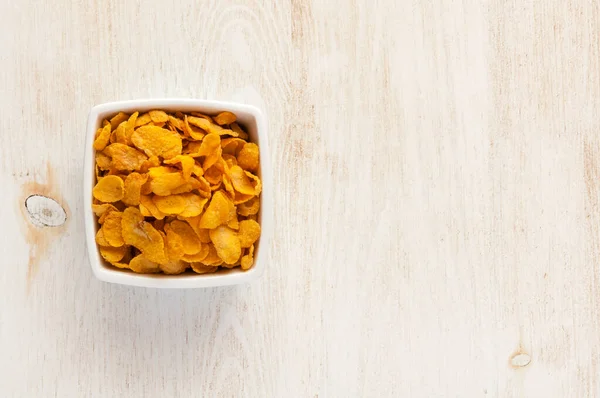 stock image Cornflakes in bowl laying on rustic table