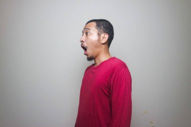 Asyalı adam beyaz arka planda izole edilmiş şok olmuş yüz portresi görünce şaşırdı.