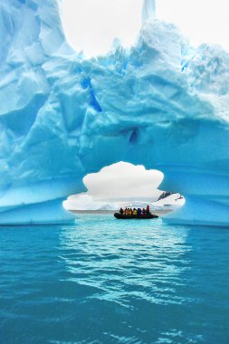 Antarktika 'da turistler buzdağına hayran olan bir dubada