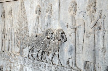 Bas reliefs that depict delegations from across the Persian empire bringing tribute to the Achaemenid kings in Persepolis, Iran clipart