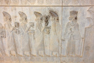 Bas reliefs that depict delegations from across the Persian empire bringing tribute to the Achaemenid kings in Persepolis, Iran clipart