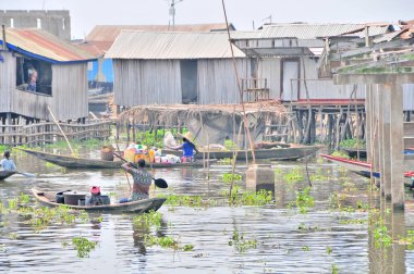 Boat dock and boats  on the  Lake Nokou near Cotonou, Benin clipart