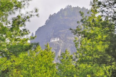 Taktshang Monastery called the tiger's nest on a rock cliff in Bhutan clipart