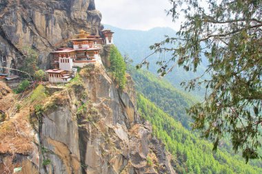 Taktshang Monastery called the tiger's nest on a rock cliff in Bhutan clipart