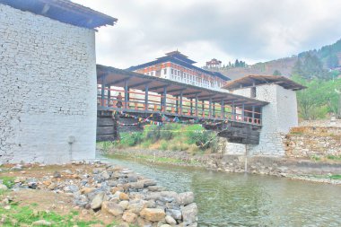 Nyamai Zam Bridge spanning the Paro Chhu river and leading to Paro Dzong, Paro, Bhutan clipart