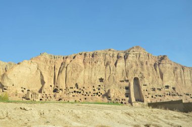 A rock with niches in which Buddha statues once stood in Bamian, Afghanistan clipart