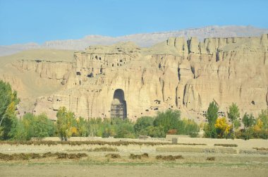 A rock with niches in which Buddha statues once stood in Bamian, Afghanistan clipart