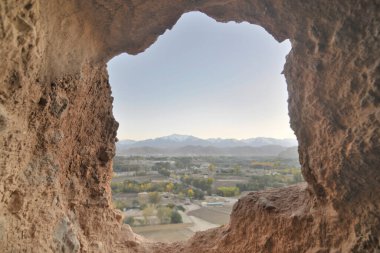 A rock with niches in which Buddha statues once stood in Bamian, Afghanistan clipart