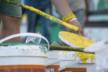 Ressamın fırçayla karıştırdığı şişelerdeki farklı renklerin resimleri.