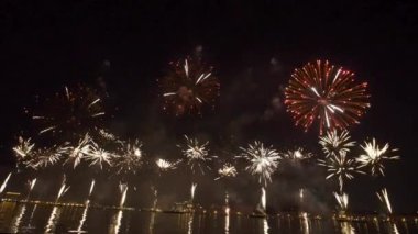 Parlak gece havai fişekleri banliyö mahallesinin ışıklarıyla parıldıyor. Kutlama Işıkları Parıldıyor. Bayram Patlaması. 