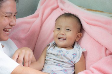 ASEAN Taylandlı çocuk gülümseyen bir yüz ve neşeli bir ruh haliyle uyur. Sağlık konsepti, sağlık sigortası, aile ilişkilerinin geliştirilmesi.