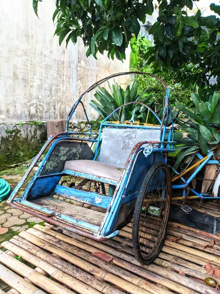 Becak is a three-wheeled mode of transportation that moves by pedaling like a bicycle.