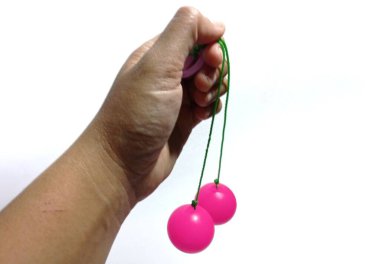 hand holding a ball of a red and green color