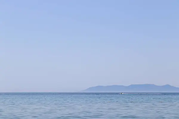 Close-up of the gentle waves of the calm sea in daylight.