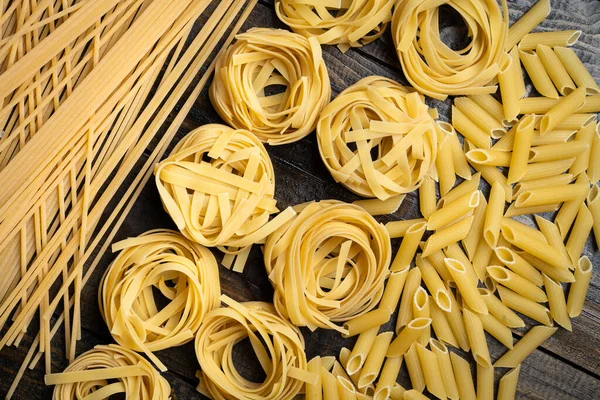 Pasta Shapes Raw Spaghetti Penne Tagliatelle Italian Cuisine Ingredients Wooden — Stock Photo, Image