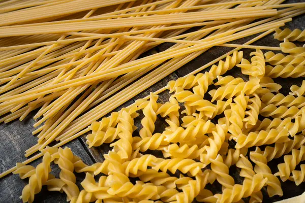 Pasta Shapes Raw Spaghetti Fusilli Italian Cuisine Ingredients Wooden Background — Stock Photo, Image